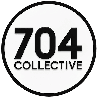 Four young professionals laughing together on a rooftop with the Charlotte skyline at golden hour